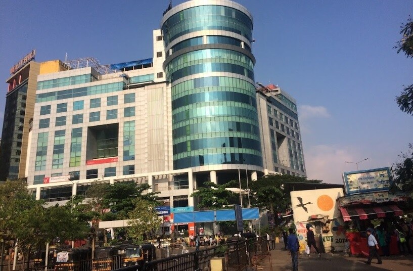 Vashi Sector 17_a large building with a large clock on the side of it